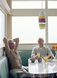 Couple sitting in room lit by natural light